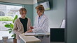 © stockbusters - Woman physician explaining insurance details to female patient in health clinic