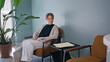 © stockbusters - Patient sitting hall healthcare clinic. Relaxed lady waiting medical appointment