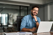 © insta_photos - Portrait of happy professional business man company employee, young smiling male businessman entrepreneur or worker looking at camera using laptop computer technology working at corporate office desk.