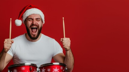 Wall Mural - Male drummer in a white t-shirt and Santa hat