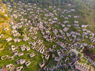 Wall Mural - Aerial view of ancient Greek ruined Kayakoy village, preserved as museum village and ghost settlement in Mugla Province of Turkey