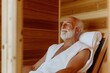 © Y_Malashkevych - An older man enjoys a moment of relaxation in a traditional wooden sauna wrapped in a towel with eyes closed feeling content in the warm inviting atmosphere