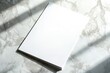 © Сергей Захаров - minimalist flyer with blank design placed on marble countertop under soft light