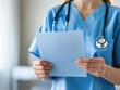 © Siripong - Healthcare professional reviewing patient information clinic room medical document indoor close-up patient care insights