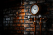 © Dmitriy - Antique brass pressure gauge and brass water pipe on an old brick wall background..