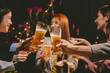 © Witoon - A lively group of friends celebrating with beer at an outdoor terrace. Raising glasses in cheerful toasts, they enjoy drinks, food, and laughter, embracing friendship, fun, and the vibrant party atmos