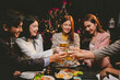 © Witoon - A group of cheerful friends celebrating, holding glasses of beer and laughing together. A lively gathering shows bonding, happiness and relaxation in a lively atmosphere.