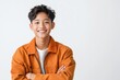© Odin AI - Young boy smiling confidently in orange jacket indoors against a plain background