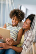 © NDABCREATIVITY - Happy african american single mother helping child with distance education. Online education