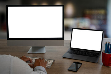 Wall Mural - young man working businessman using a desktop computer of the blank screen