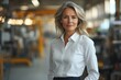 © stockphoto02 - Confident businesswoman in a factory setting, embodying strength and leadership.