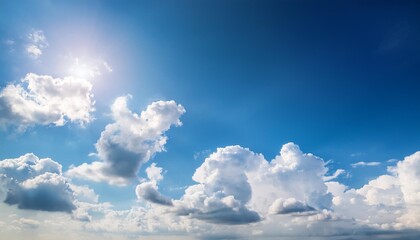 blue sky background with fluffy white clouds and bright sunlight