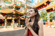 © itchaznong - Joyful Celebration of Chinese New Year: Woman Traveling and Embracing Traditions at a Vibrant Temple