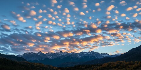 Poster - Evening light casts a beautiful glow on altocumulus clouds in the sky, creating a stunning contrast over the silhouette of majestic mountains, showcasing the allure of altocumulus clouds.