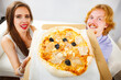 © Voyagerix - Funny couple eating pizza