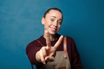 Wall Mural - smiling and looking happy, carefree and positive, gesturing victory or peace with one hand