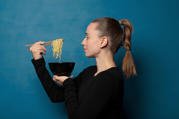 Wall Mural - blonde young pretty chef woman with a ramen bowl