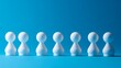 © Matthew - A row of white pawn-like figures against a blue background.