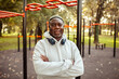 © Marko Geber - Senior man working out with headphones at a park