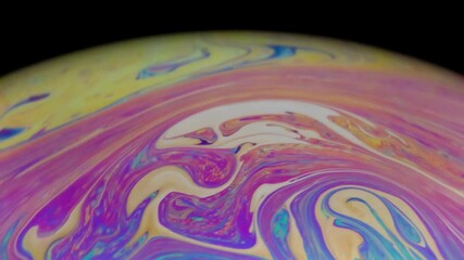 Wall Mural - Closeup video of a soap bubble showing thin film interference concept and the resulting different colors of light with each moving and swirling shapes. Perfect for illustrating concepts of physics.