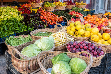 Fresh market produce at an outdoor farmer's market. Shop selling various kinds of vegetables