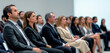 © GustavsMD - Focused Business Professionals Attending a Corporate Conference in a Modern Setting