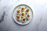 Deviled eggs on plate with spices and herbs