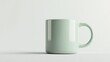 © Napasnan - A thin, minimalist ceramic coffee mug in a soft green hue, with clean edges and a straight handle, isolated on white