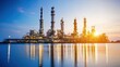 © Thanarat - A sunset view of an industrial oil refinery set against a calm water surface, showcasing towering structures and a vibrant sky.