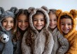 © Julia - A group of kids dressed as various animals, standing in a line and smiling for a group photo on a white backdrop.