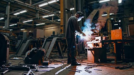 Aufkleber - Welder at work in a manufacturing facility creating sparks and smoke during metal fabrication in an industrial setting