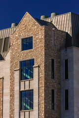 Wall Mural - A building with a stone facade and a pointed roof