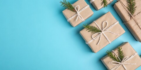 Poster - Rustic Kraft Paper Gift Boxes Tied with Twine and Decorated with Greenery on a Light Blue Background