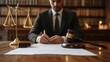 © afif - Lawyer signing legal document at desk.