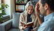 © natakot - A woman with long, silver hair reads from a book while a man with dark hair listens intently, showing a thoughtful expression. This intimate scene captures the essence of connection and shared