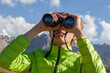 © Regisser.com - Man with binoculars at the mountain.Young man using binoculars. Man looking through binoculars at the coast.