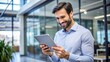 © engincan - male employee looking at tablet and happy