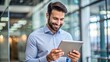 © engincan - male employee looking at tablet and happy