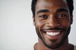 © Anjali - Joyful Afro American man smiling against white background.