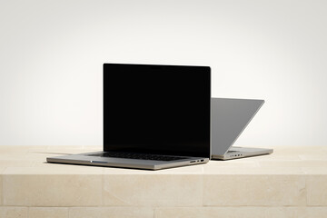 Wall Mural - opened laptop with a blank screen on the light brick podium