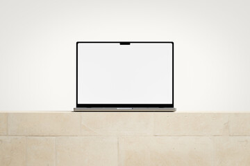 Wall Mural - opened laptop with a blank screen on the light brick podium