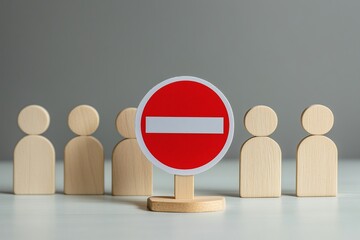 Road Stop sign blocking way for wooden human figures on white table isolated with white highlights