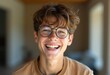 © Vibudhaart - A cheerful teenage boy with glasses smiles broadly, radiating joy and happiness.