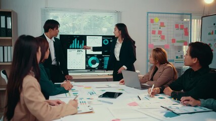 Fototapete - Office workers and managers gather around an interactive screen, actively discussing and analyzing financial charts and data during a productive business meeting