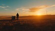 © alisya - Silhouette of person in field at golden sunset with wind turbine in background.