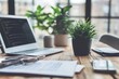 © atar - Laptop, documents, and plants on a wooden desk.  Concept of modern workspace.