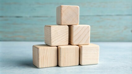 Aufkleber - A Simple Stack of Wooden Blocks Arranged in a Pyramid Shape on a Light Blue Wooden Surface