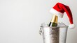 © Ziyan Yang - Champagne bottle wearing a Santa hat resting in an ice bucket during the festive holiday season, A bottle of champagne with a red Santa Claus cap in an ice bucket Isolate on white background