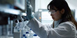 © GulzarHussain - Female scientist working in laboratory with modern research equipment, Focused researcher conducting experiments in controlled environment