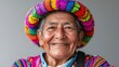 © kinara art design - Portrait of a smiling elderly indigenous man wearing a colorful hat.